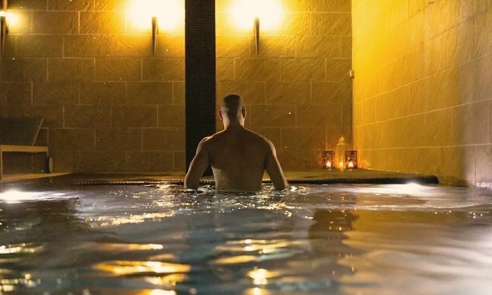 Person in the hydromassage pool with warm light