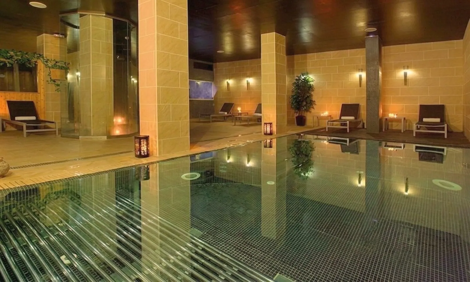 Indoor pool with loungers and candles