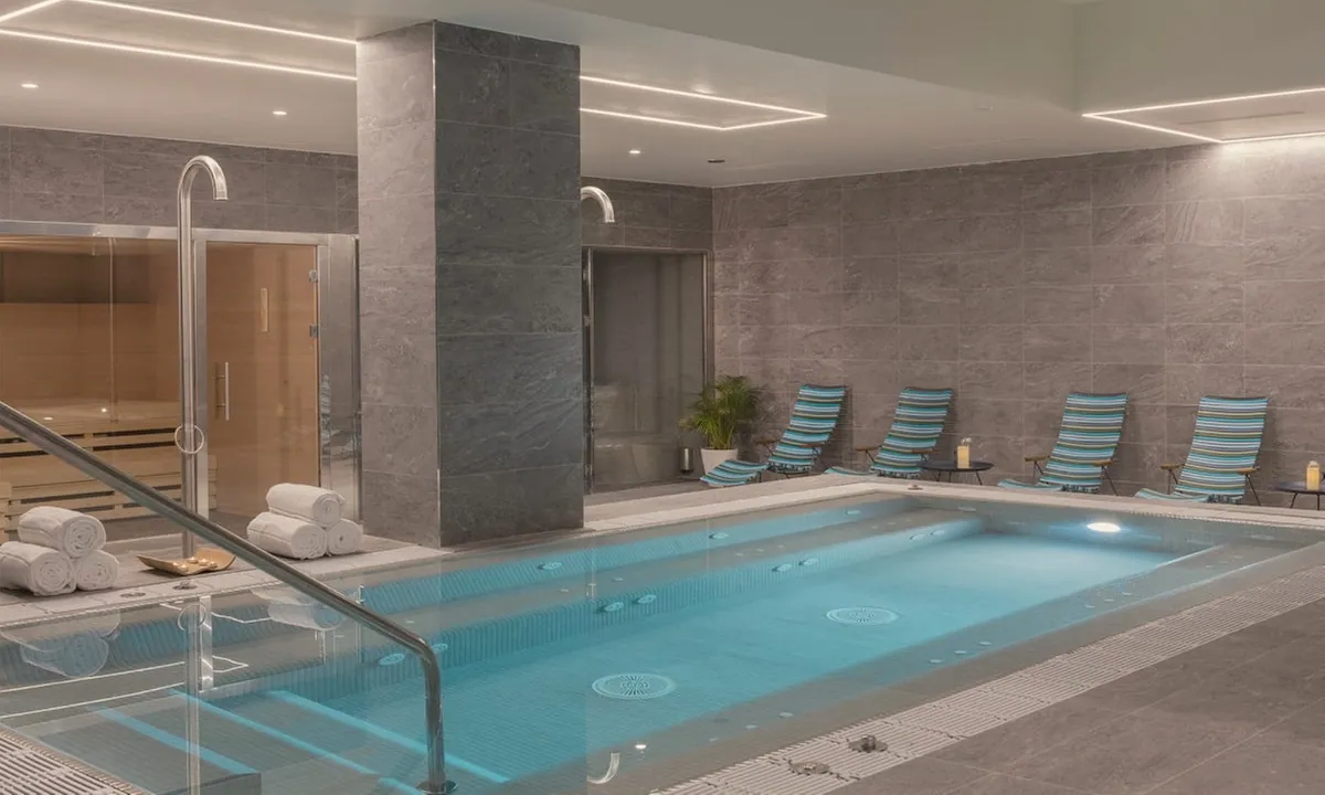 Indoor pool with striped loungers